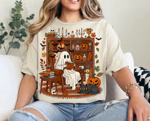 Load image into Gallery viewer, &quot;Read Between the Spooks: Cozy Ghost in Library Tee&quot; - Personalized Gift for Book Lovers &amp; Halloween Enthusiasts Shirts PopCulturePrints
